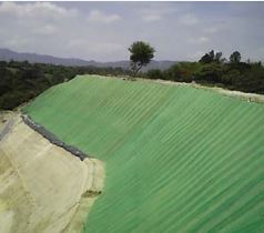 Green turf reinforcement mats installed on steep slope