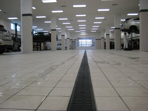 ACO K100 trench drain set in an auto garage floor
