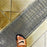 ACO K200 trench drain with a mesh grate in a tiled floor
