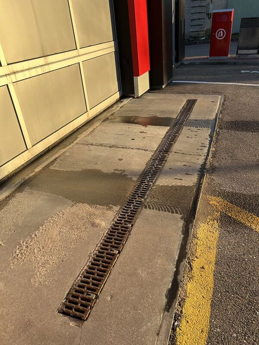 ACO PowerDrain S100K trench drain along a commercial concrete apron
