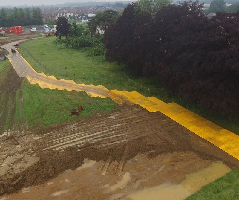 Aerial view of XtremeMat ground protection mats forming a temporary road

