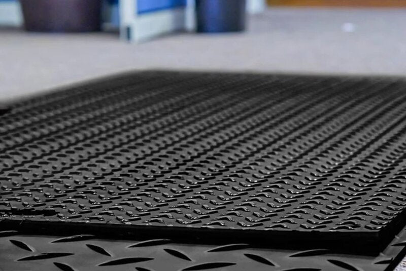 Close-up of the traction tread surface on a Blue Gator ground protection mat
