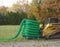 Pallet of coiled Filtrexx SiltSoxx silt socks staged beside a skid steer with fall foliage in the background
