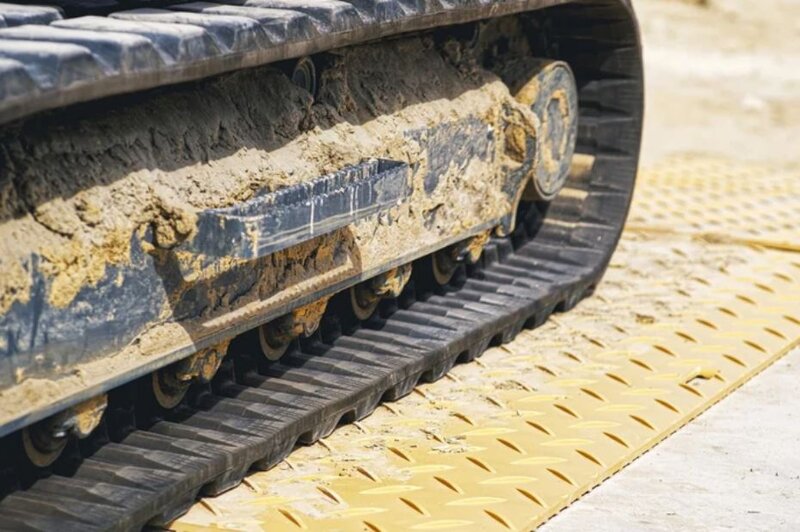 Heavy equipment operating on a Blue Gator ground protection mat
