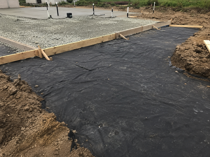 Non-woven geotextile fabric under the gravel subgrade of a concrete slab
