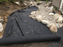 Non-woven geotextile fabric underlayment beneath a backyard dry creek bed
