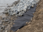 Non-woven geotextile fabric beneath shoreline riprap for erosion control

