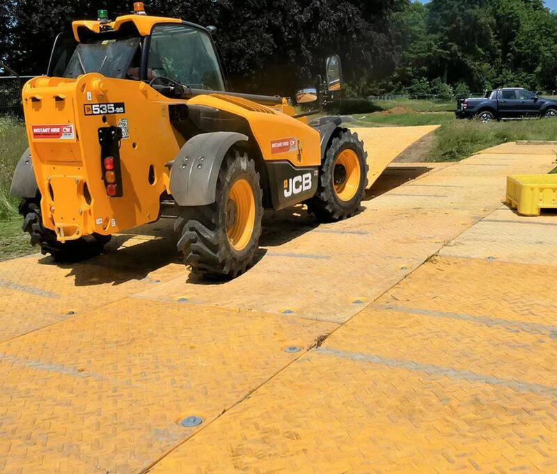 Placing XtremeMat ground protection mats at a jobsite
