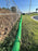Green silt sock installed for perimeter control along a chain link fence at a new construction site
