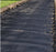 Woven geotextile driveway fabric laid across the full width of a driveway
