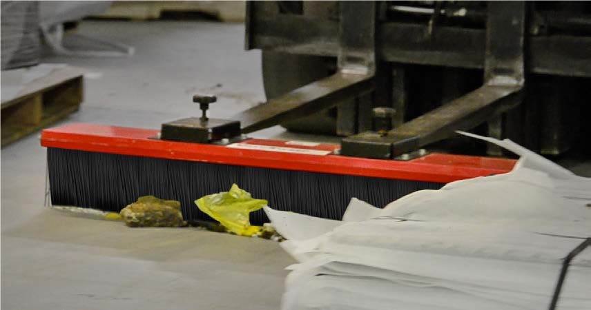 Forklift broom being used in warehouse